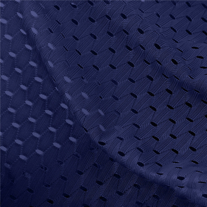 Close-up of navy blue perforated mesh fabric with a zigzag texture and small oval holes 2