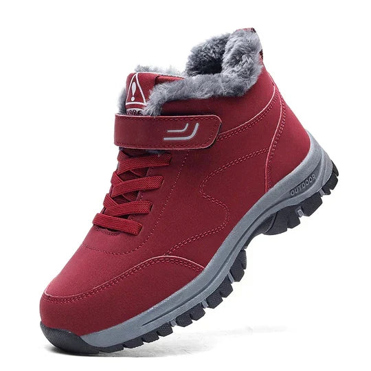 Red high-top boot with fluffy gray lining, hook-and-loop strap, laces and a gray rugged sole, side view 5