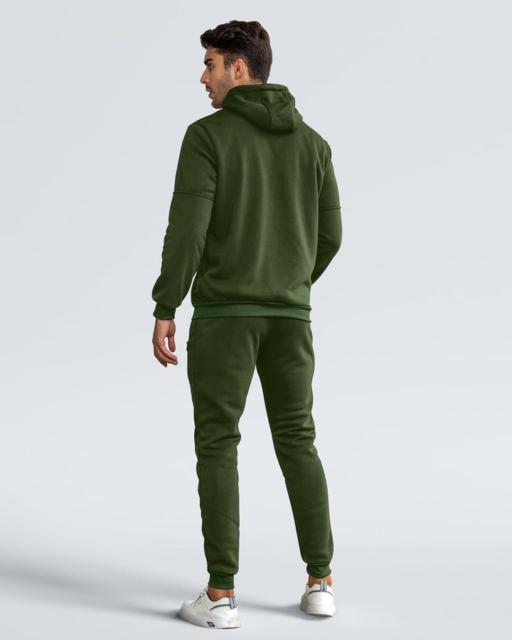 Back view of a man wearing the olive green hoodie and cuffed joggers, head turned left 7
