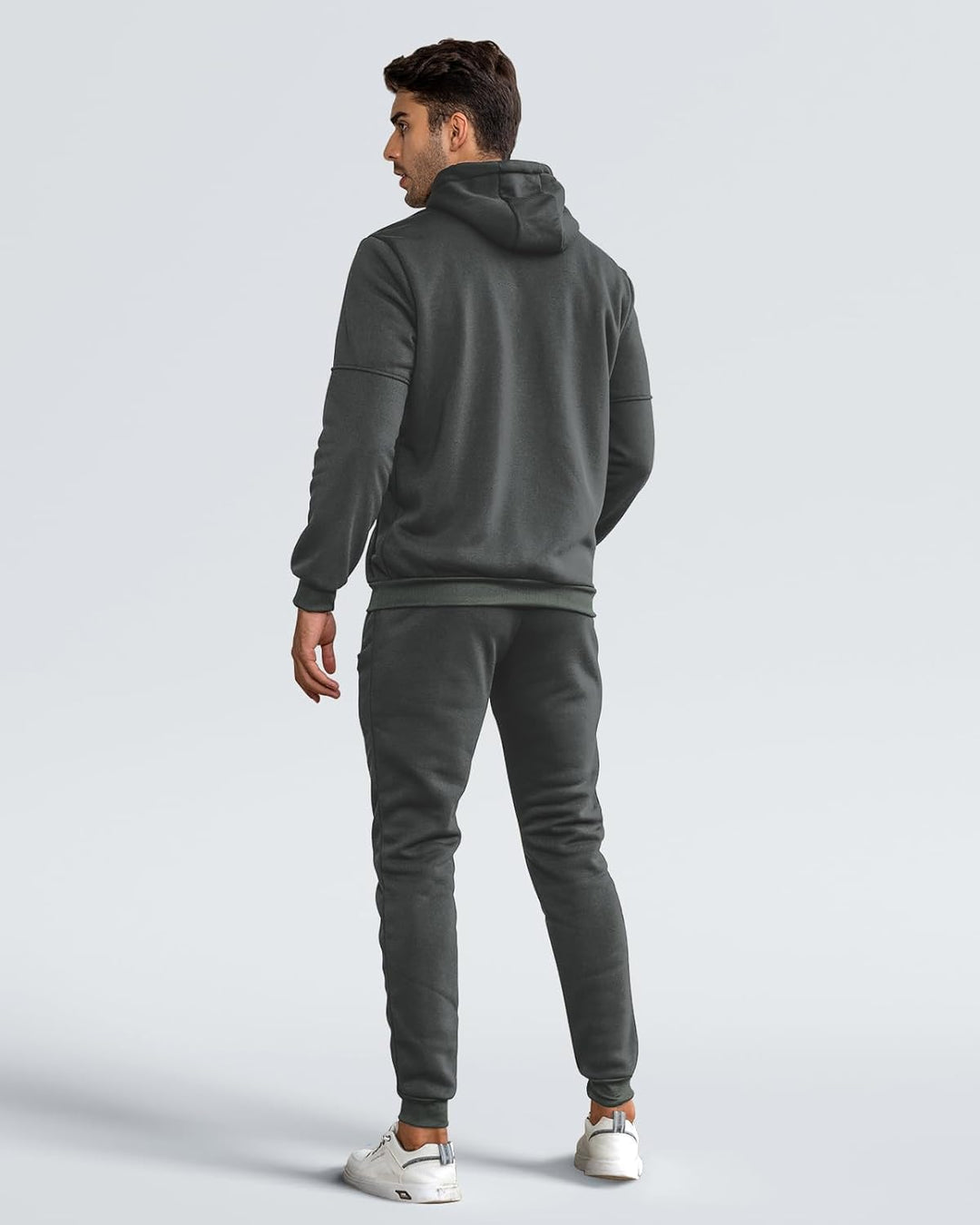 Back view of a man wearing a charcoal gray hoodie with ribbed hem and matching joggers 5