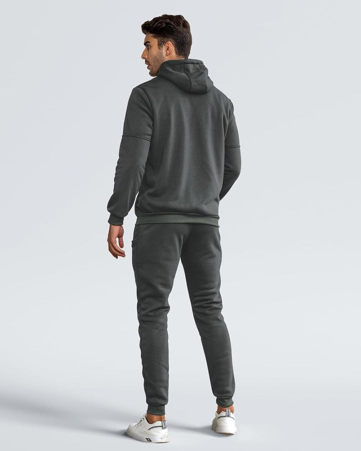 Back view of a man wearing a charcoal gray hoodie with ribbed hem and matching joggers 5