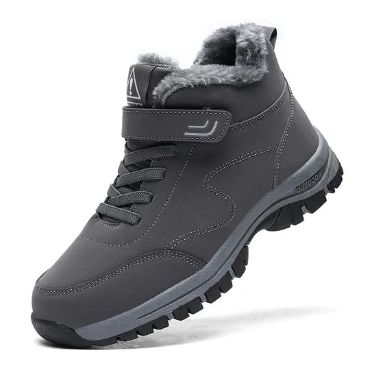 Dark gray high-top boot with plush lining, strap, laces and a black lugged sole, angled side view 7