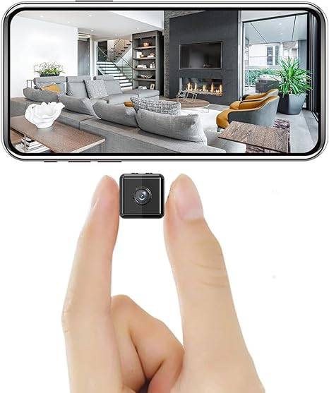 Tiny cube camera held between two fingertips, with a smartphone above showing a live view of a living room 2