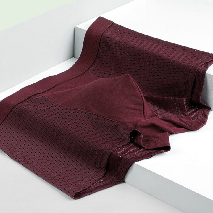 Burgundy boxer briefs folded over the edge of white steps, showing mesh side panels and a smooth center pouch 5