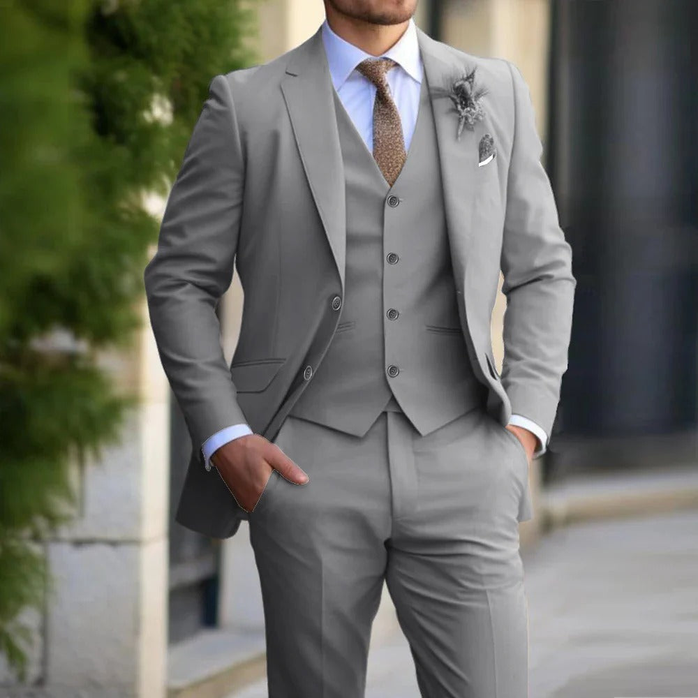 Same suit and vest in light gray, worn with a white shirt, brown tie and boutonniere 3