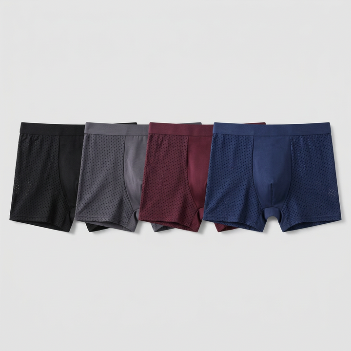 Four mesh-panel boxer briefs in black, gray, burgundy and navy laid side by side 3