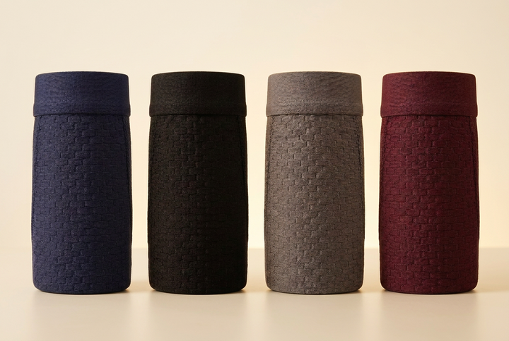 Four rolled-up boxer briefs in navy, black, gray and burgundy, standing upright and showing a woven brick-like texture 3