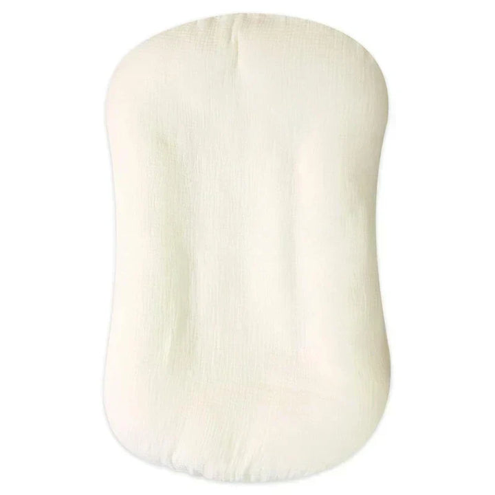 Empty cream crinkled-cotton lounger shown from above with a soft center depression 9