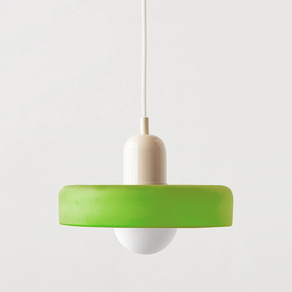 Lime green glass disc pendant with a cream cap and white cord on a light background 55
