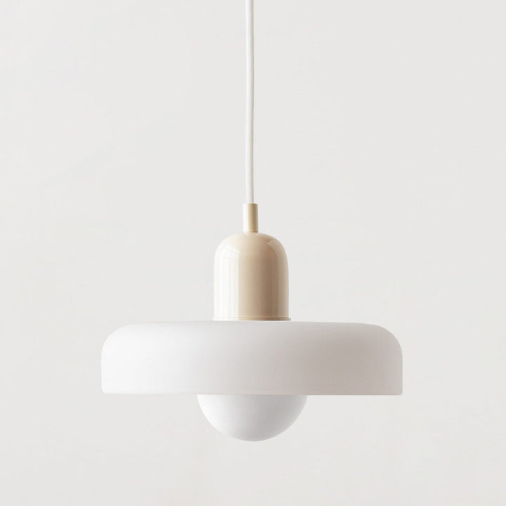 Pendant lamp with a matte white disc shade, cream cap and white cord on a plain background 46