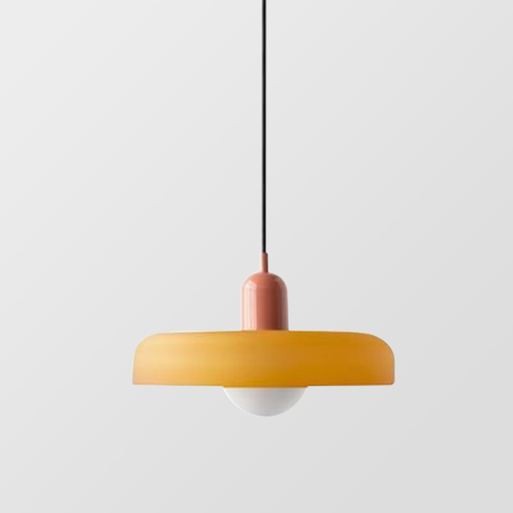 Wide amber glass shade with a salmon pink cap and black cord against a gray backdrop 23