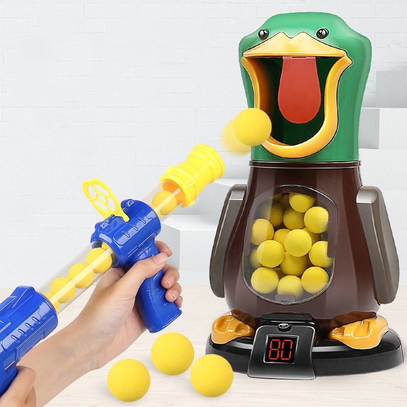 Hand holding a blue and yellow blaster as a yellow foam ball flies into the duck's mouth 3