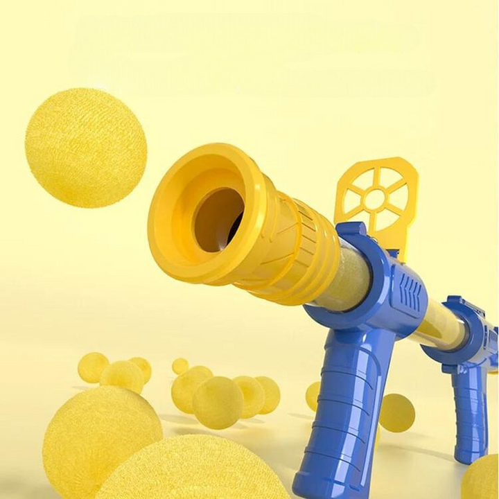 Close-up of the yellow barrel and blue handle of the blaster with yellow foam balls floating around 4