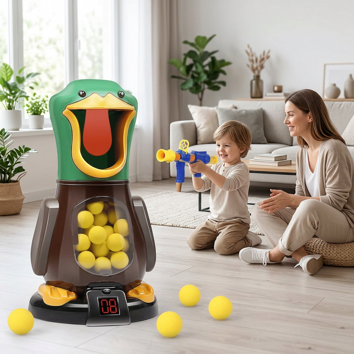 Smiling boy aims a blue and yellow foam blaster at the duck target while his mother watches in a living room 1