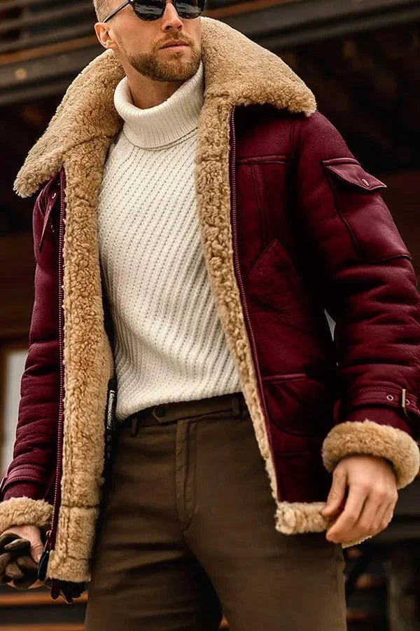 Close-up of the jacket in burgundy leather with a tan fleece collar and cuffs, worn over a cream sweater 4