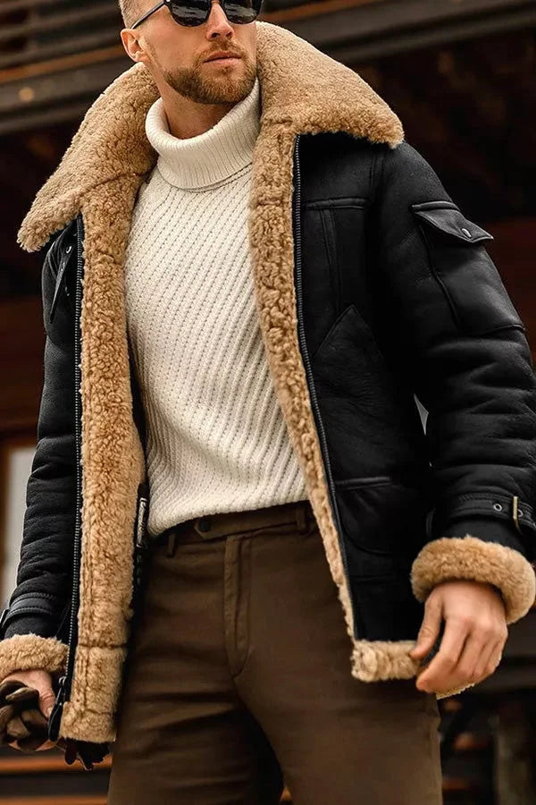 Close-up of the jacket in black leather with a tan fleece collar and cuffs, worn over a cream sweater 5