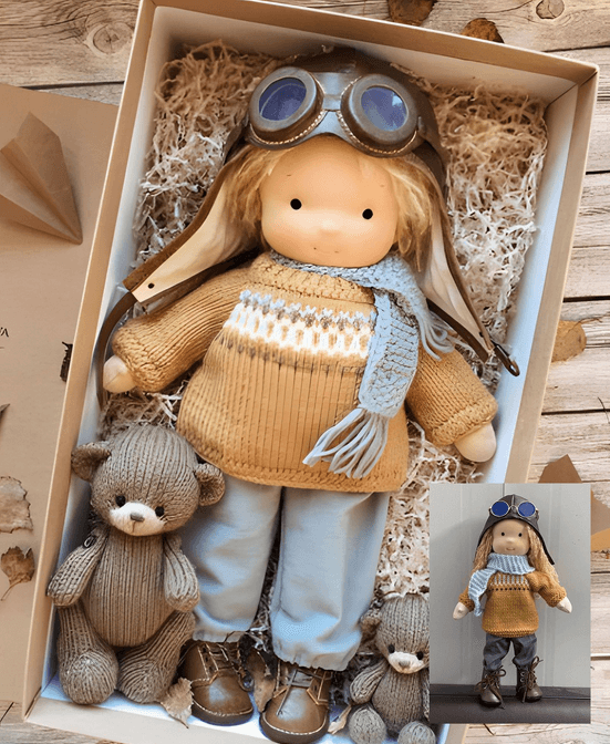 Boy doll in aviator cap with goggles, mustard sweater and blue scarf lies in gift box with two knitted bears 2