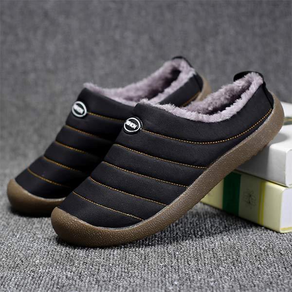 Pair of black quilted slippers with gray fleece lining, one leaning on books 8