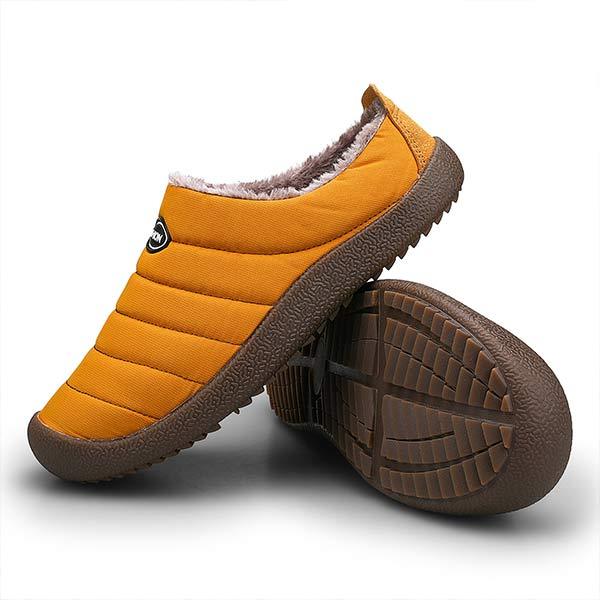 Mustard slipper beside another turned over to show the treaded brown rubber outsole 12