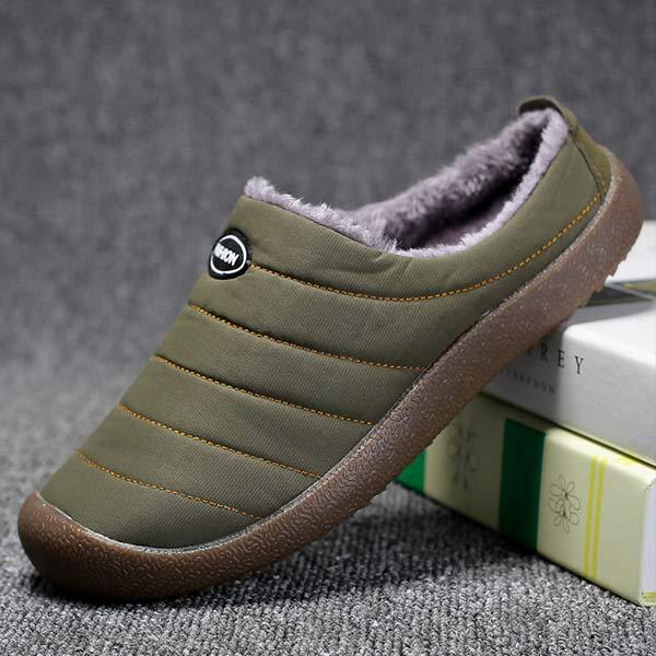 Single olive green slipper propped against books, showing the quilted side and brown rubber sole 4