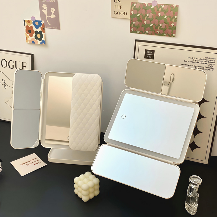 Two cream mirrors on a dark desk, one with a quilted panel and one laid open with side panels 4