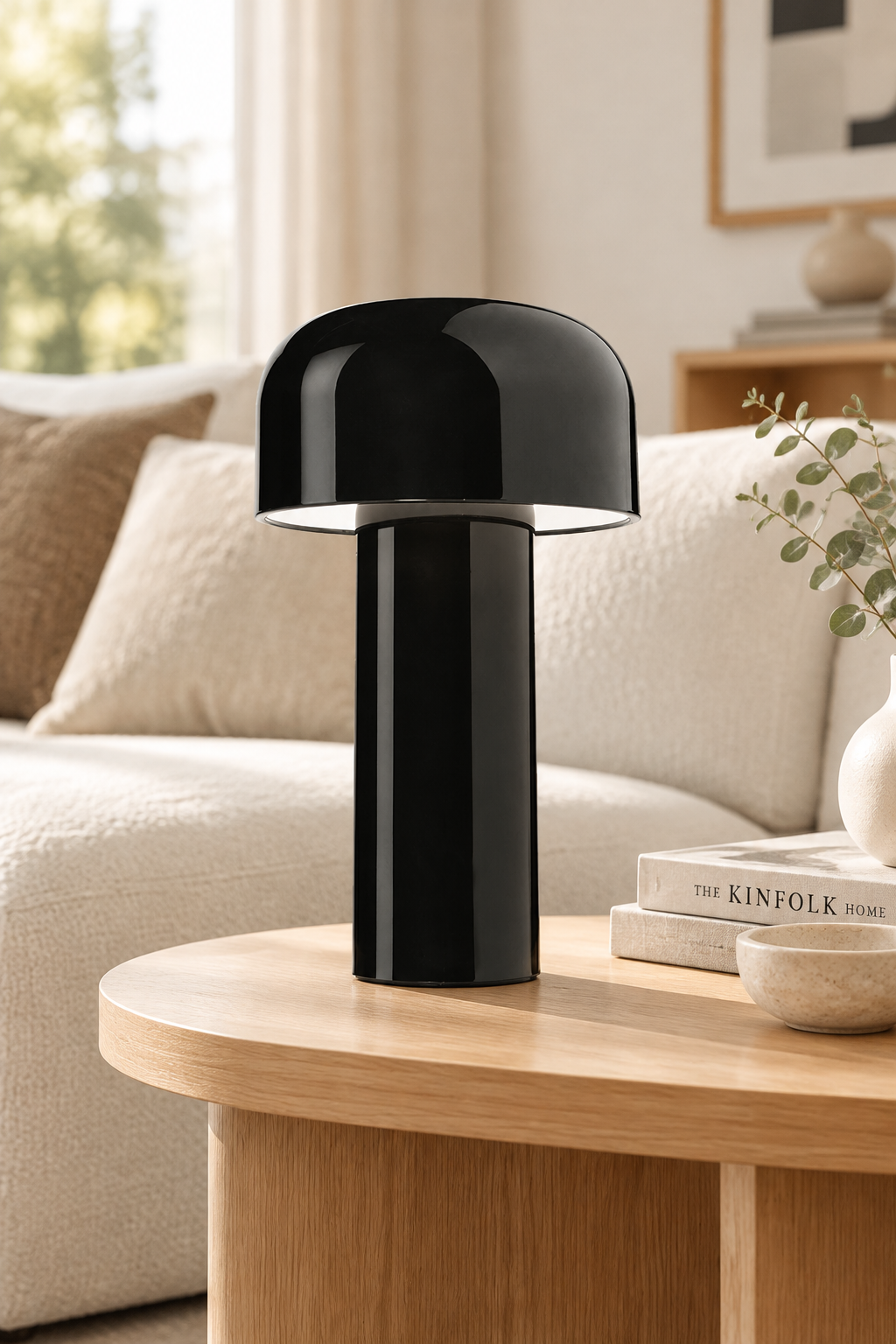 Glossy black mushroom lamp on a curved wooden side table beside a cream sofa 30