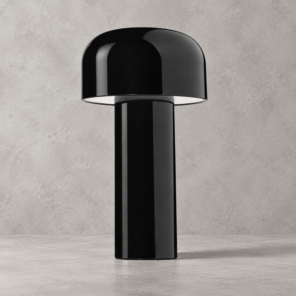 Glossy black lamp with domed shade standing on a concrete-look surface, unlit 33