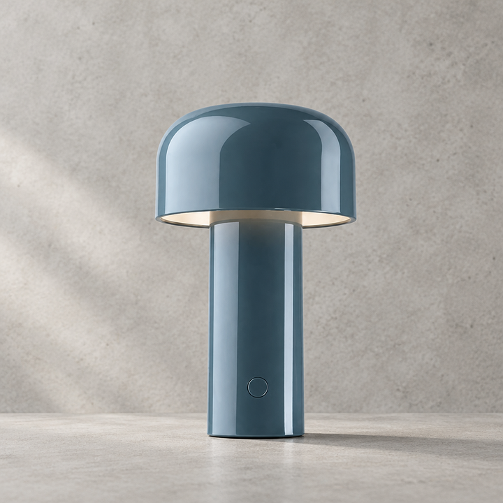 Glossy blue-gray lamp with round touch button on the stem, against a textured wall 30