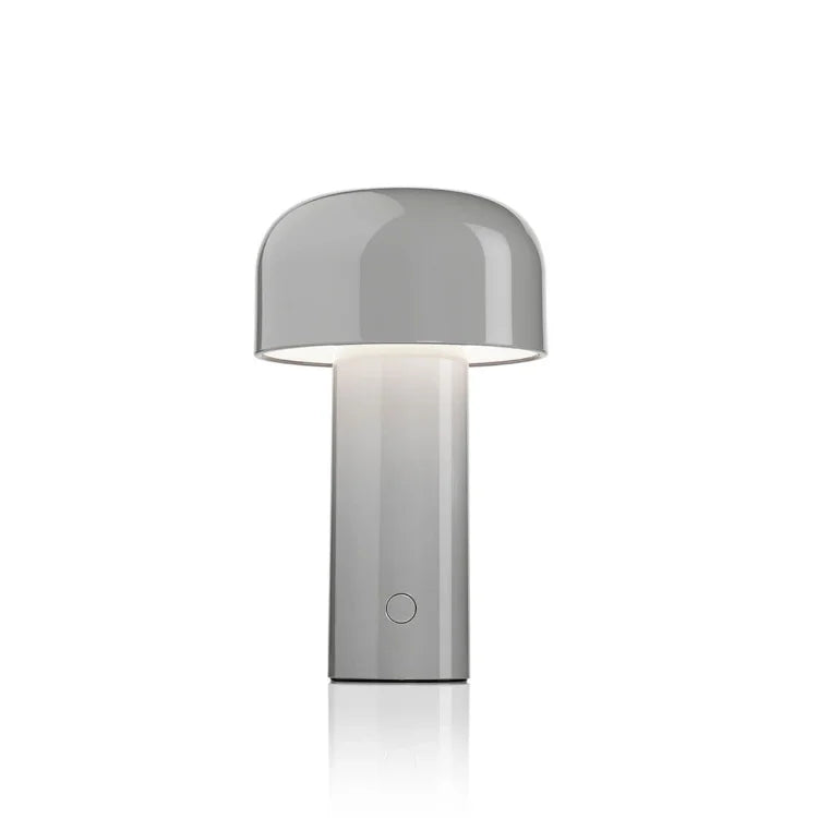 Glossy gray mushroom-shaped table lamp glowing softly beneath its dome shade, on a plain white background 5