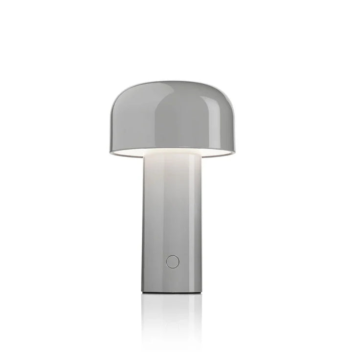 Glossy gray mushroom-shaped table lamp glowing softly beneath its dome shade, on a plain white background 5