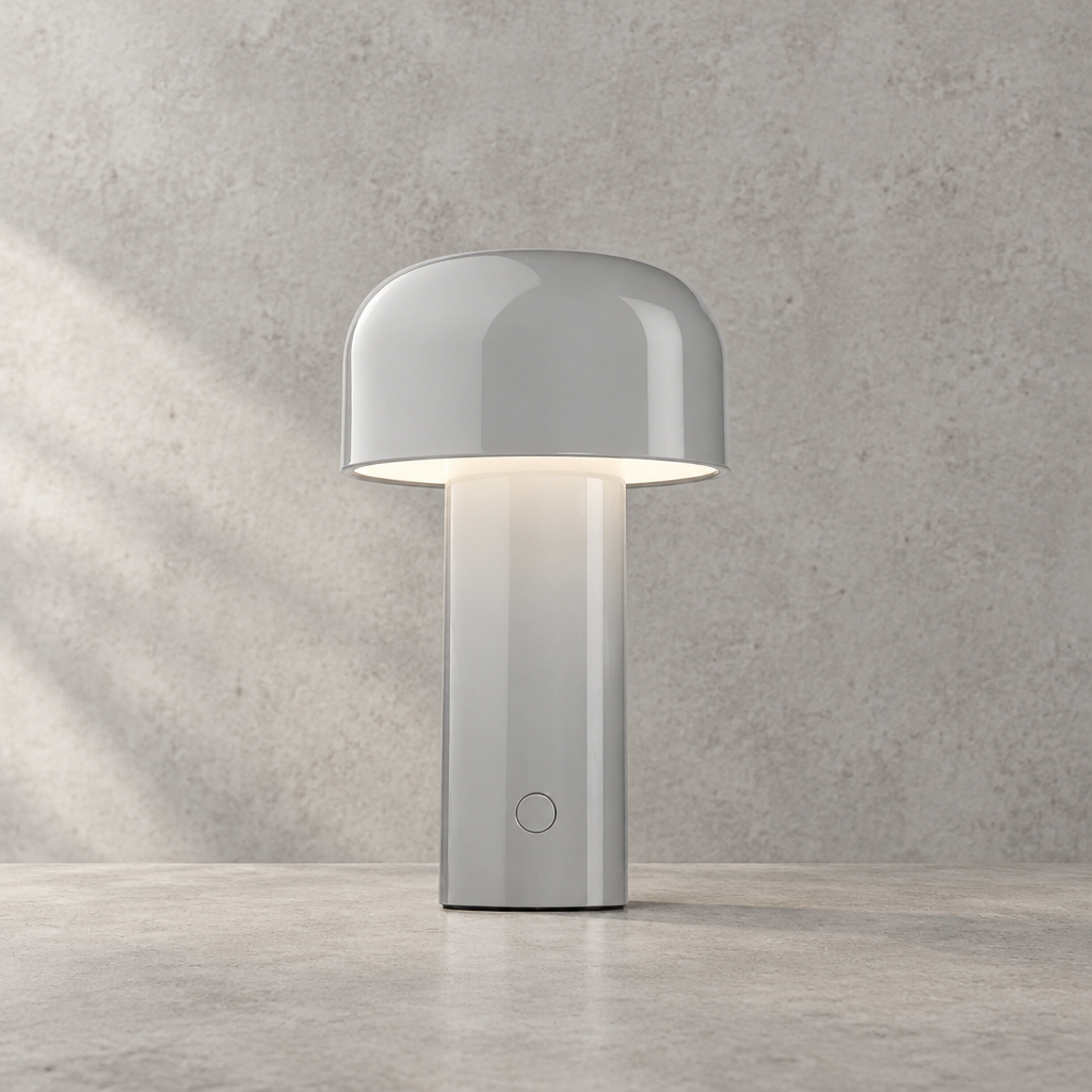 Glossy light gray lamp lit against a textured wall, touch button on the stem 32