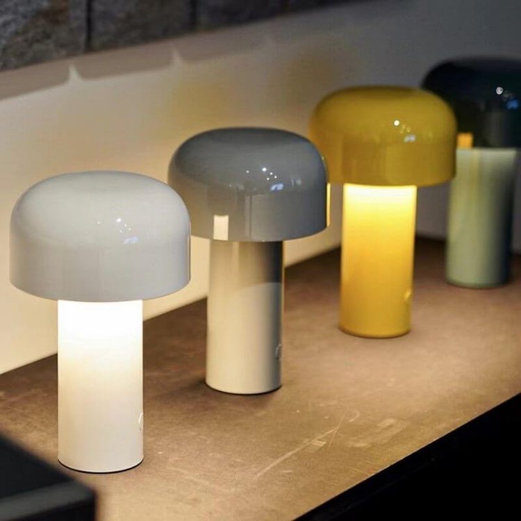 Row of lit lamps in white, gray and yellow on a shelf, with a dark one behind 19