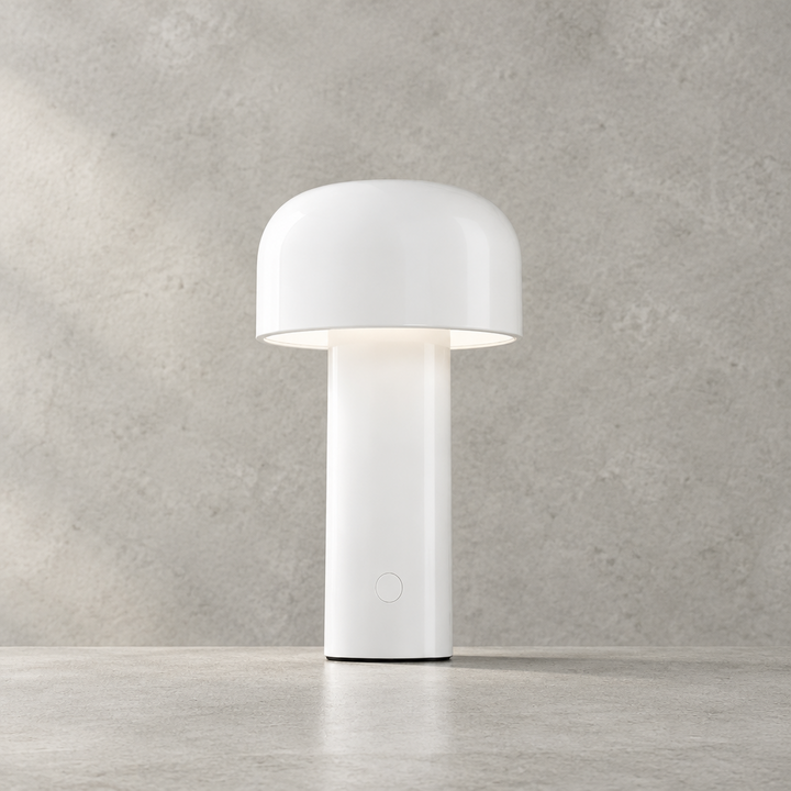 White lamp lit against a concrete-textured wall, with the touch button visible on the base 28