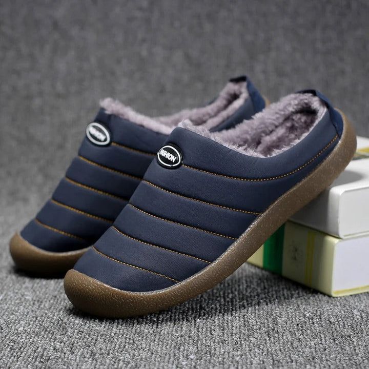 Navy blue quilted slippers with fuzzy lining, one leaning on a stack of books 5