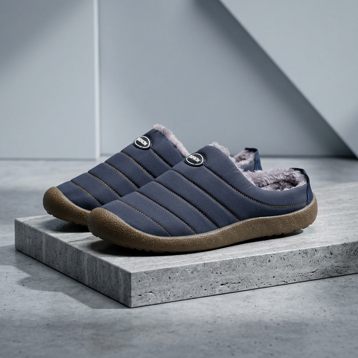 Navy blue quilted slippers on a concrete block against a soft gray backdrop 18