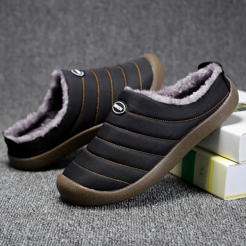 Black quilted slippers from the front, one angled up to show the fleece collar 9
