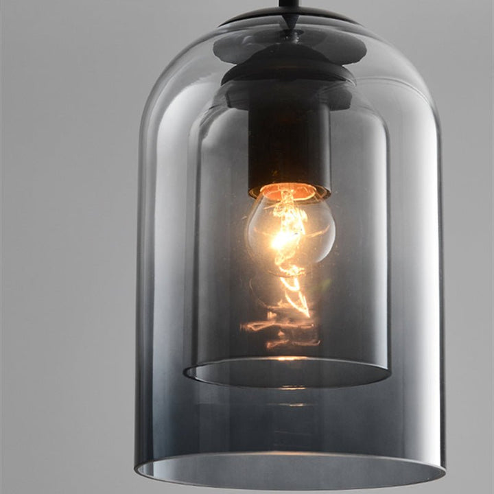 Close-up of the smoke gray glass layers with the warm filament bulb glowing inside 8