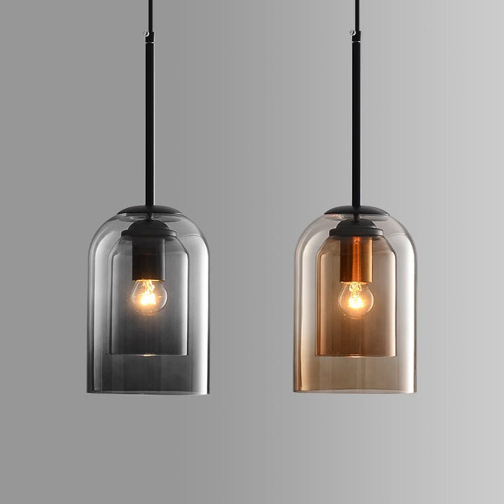 Smoke gray and amber versions hang side by side against a gray backdrop, both lit 2