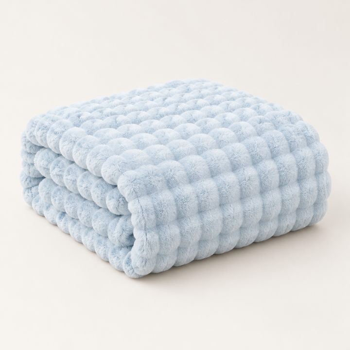 Light blue plush blanket folded in a neat stack on a plain background, showing its bubble texture 12