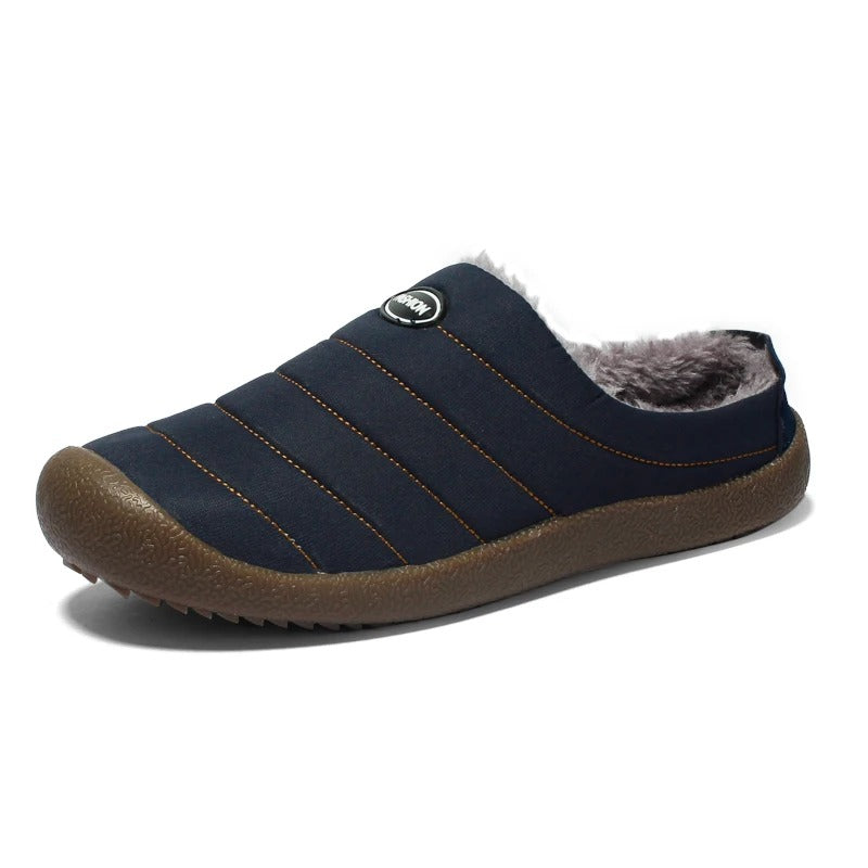 Single navy blue quilted slipper on white background with gray fleece lining and brown sole 15