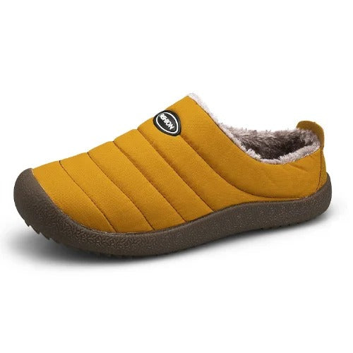 Single mustard yellow quilted slipper on white, showing the fleece lining and brown sole 13