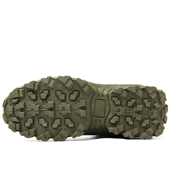 Close-up of the olive green boot's outsole, showing deep, blocky lug tread and a central flat pad 22