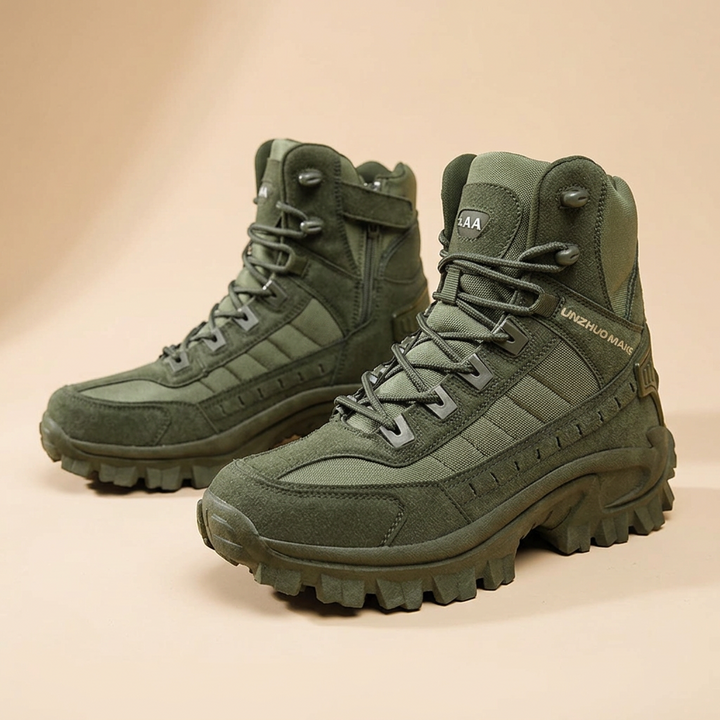 Pair of olive green lace-up boots at an angle, one showing a side zipper and strap 25