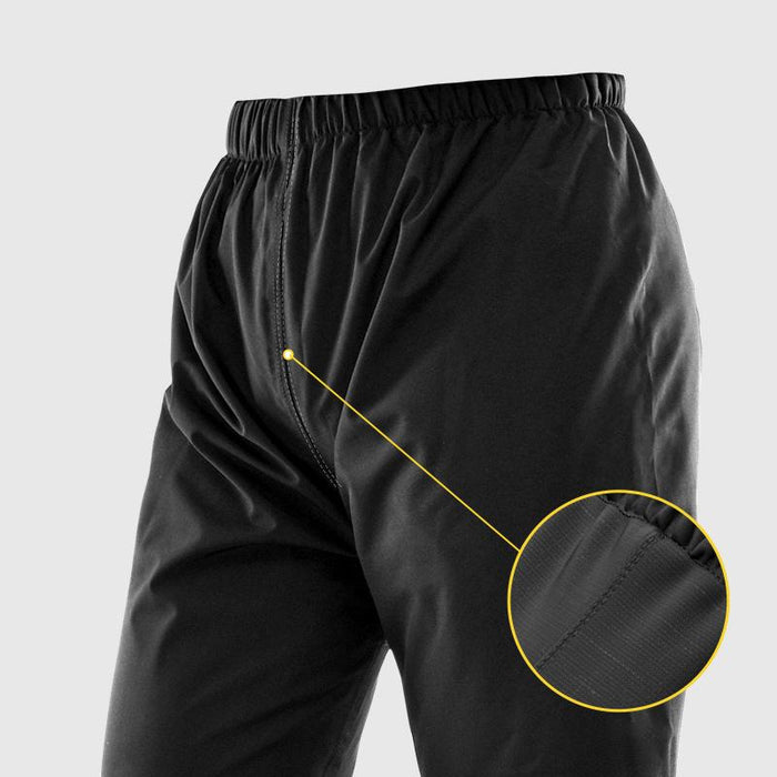 Black rain pants with elastic waistband and a circular close-up of the taped inner seam 13