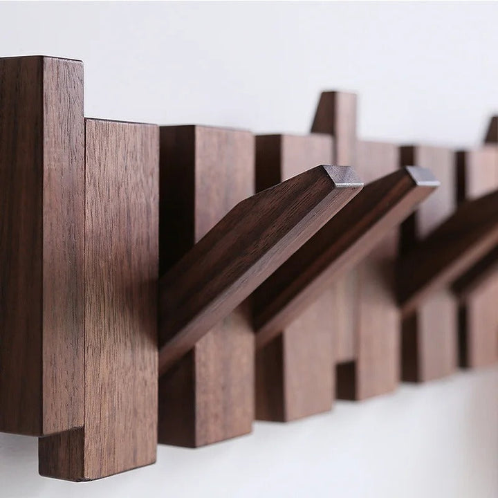 Close-up of dark wood grain and several hooks folded out from the rack 7
